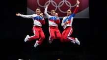Gold medallist Russia's sabre team celebrate on podium during the medal ceremony for the womens team sabre during the Tokyo 2020 Olympic Games at the Makuhari Messe Hall in Chiba City, Chiba Prefecture, Japan, on July 31, 2021.