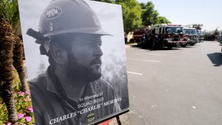 SAN BERNARDINO, CALIFORNIA - SEPTEMBER 25: A photograph of fallen Big Bear Interagency Hotshot Charles Morton, a firefighter who was killed battling the El Dorado wildfire, is displayed at a memorial service for Morton on September 25, 2020 in San Bernardino, California. Morton was a 14-year veteran with the U.S. Forest Service. The El Dorado fire has scorched more than 22,000 acres in Southern California.