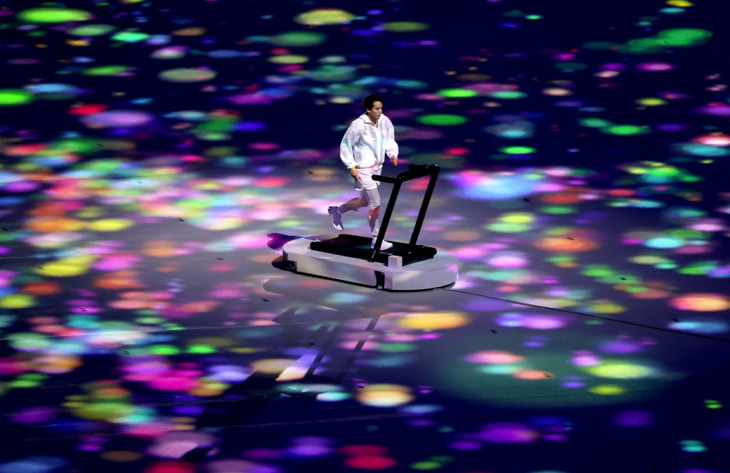 A performer symbolizing athletes training alone, yet still united with all, runs on a treadmill during the Opening Ceremony of the Tokyo 2020 Olympic Games at Olympic Stadium on July 23, 2021 in Tokyo, Japan.