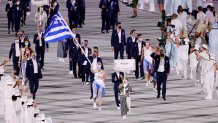 Flag bearers Anna Korakaki and Eleftherios Petrounias of Team Greece lead their team in during the Opening Ceremony of the Tokyo 2020 Olympic Games at Olympic Stadium on July 23, 2021 in Tokyo, Japan. Greece leads the delegation first as a nod to the Olympic's Greek origins.