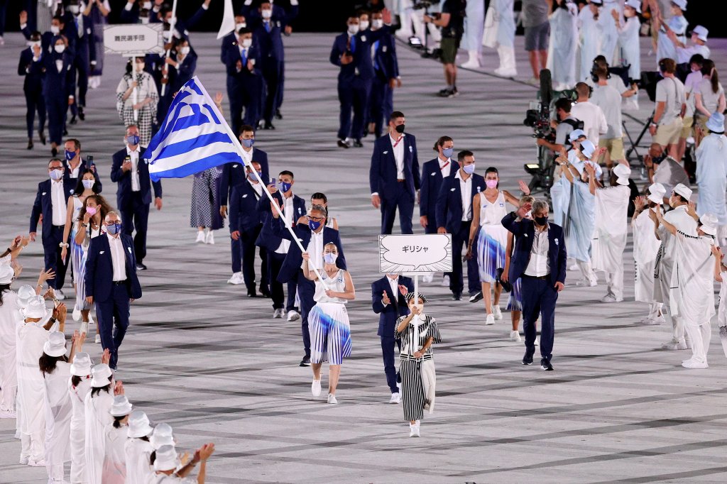 Flag bearers Anna Korakaki and Eleftherios Petrounias of Team Greece lead their team in during the Opening Ceremony of the Tokyo 2020 Olympic Games at Olympic Stadium on July 23, 2021 in Tokyo, Japan. Greece leads the delegation first as a nod to the Olympic's Greek origins.