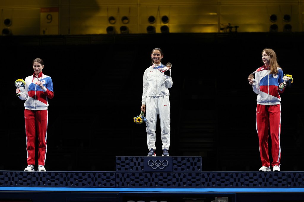 From left: Silver medalist Inna Deriglazova of Team ROC, gold medalist Lee Kiefer of Team United States and bronze medalist Larisa Korobeynikova of Team ROC pose on the podium during the medal ceremony for the Women's Foil Individual Fencing Gold Medal event on day two of the Tokyo 2020 Olympic Games at Makuhari Messe Hall on July 25, 2021, in Chiba, Japan.