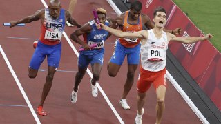 Poland's Kajetan Duszynski, gold medalist, the Netherlands' Ramsey Angela, Dominican Republic's Alexander Ogando, silver medalist, and the USA's Vernon Norwood (R-L), bronze medalist, finish the 4x400m mixed relay athletics final during the 2020 Summer Olympic Games
