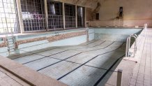 ELSTAL, GERMANY - MAY 17: A swimming pool lies abandoned in the former swim hall at the site of the 1936 Berlin Olympic Village on May 17, 2021 in Elstal, Germany. A German real estate developer called Terraplan is constructing and renovating buildings on a large portion of the former Olympic Village site in what local authorities are hoping is the first phase of investor commitment to developing the entire site. Built for the 1936 Berlin Olympics the village later served as an infantry school for the Nazi-era Wehrmacht and a military hospital during World War II. After the war the Soviet Army took it over as a military base and also as a training facility for its own Olympic athletes. A number of the original buildings still stand at the site, including housing for athletes, a swim hall, a gym, other training facilities and a theatre. Located just west of Berlin, the site has finally become interesting to investors due to the rapid rise in value of the Berlin real estate market over the last decade. (Photo by Maja Hitij/Getty Images)