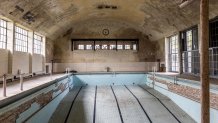 ELSTAL, GERMANY - MAY 17: A swimming pool lies abandoned in the former swim hall at the site of the 1936 Berlin Olympic Village on May 17, 2021 in Elstal, Germany. A German real estate developer called Terraplan is constructing and renovating buildings on a large portion of the former Olympic Village site in what local authorities are hoping is the first phase of investor commitment to developing the entire site. Built for the 1936 Berlin Olympics the village later served as an infantry school for the Nazi-era Wehrmacht and a military hospital during World War II. After the war the Soviet Army took it over as a military base and also as a training facility for its own Olympic athletes. A number of the original buildings still stand at the site, including housing for athletes, a swim hall, a gym, other training facilities and a theatre. Located just west of Berlin, the site has finally become interesting to investors due to the rapid rise in value of the Berlin real estate market over the last decade. (Photo by Maja Hitij/Getty Images)