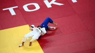 France's Amandine Buchard (white) competes with Switzerland's Fabienne Kocher during their judo women's -52kg semifinal A bout during the Tokyo 2020 Olympic Games at the Nippon Budokan in Tokyo on July 25, 2021.
