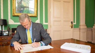 Gov. Charlie Baker signs Massachusetts' budget into law on Friday, July 16, 2021.