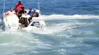 A boat taking on water near Gloucester's "The Cut"