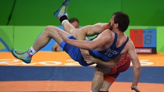 Aug 21, 2016; Rio de Janeiro, Brazil; Kyle Frederick Snyder (USA), red, and Albert Saratov (ROM) compete in a men's freestyle 97kg wrestling match during the Rio 2016 Summer Olympic Games at Carioca Arena 2.