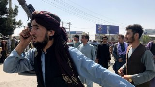 A member of Taliban forces inspects the area outside Hamid Karzai International Airport in Kabul, Afghanistan August 16, 2021.