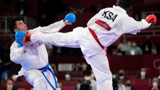 Sajad Ganjzadeh of Iran, left, is injured while competing against Tareg Hamedi