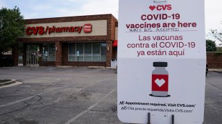 An information sign regarding COVID-19 vaccines is seen outside of a CVS store in Chicago, Ill.