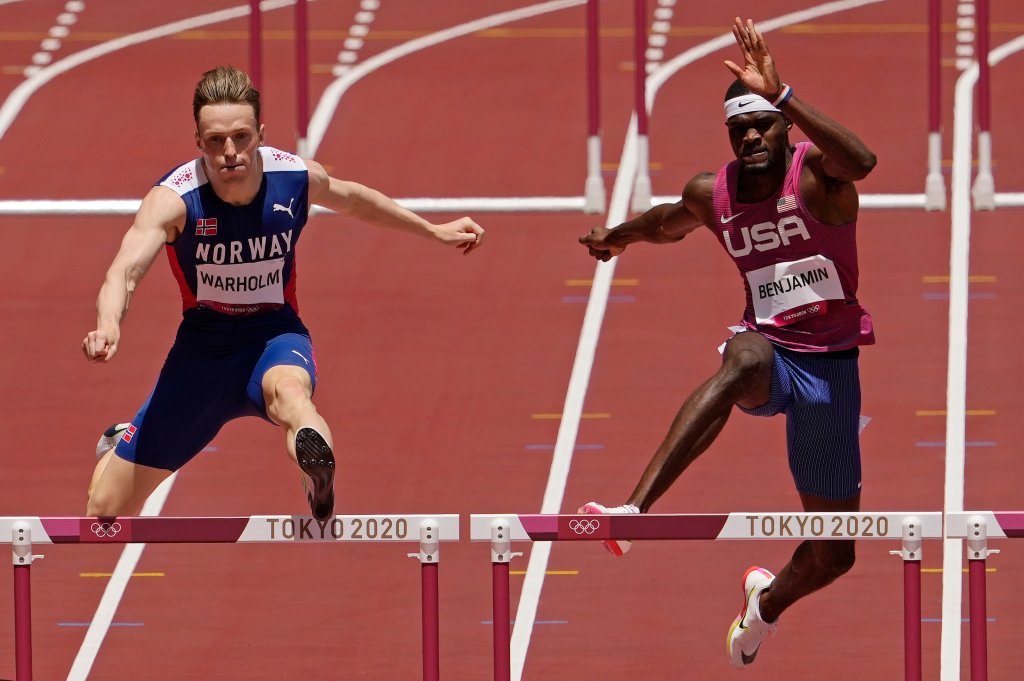 Karsten Warholm, of Norway, left, clears the final hurdle before winning the gold medal ahead of Rai Benjamin, of United States in the final of the Men's 400-Meter Hurdles at the 2020 Olympics, Tuesday, Aug. 3, 2021, in Tokyo, Japan.
