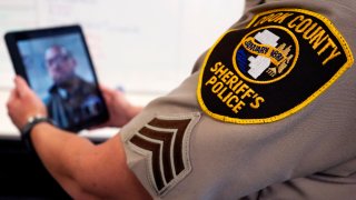 Sheriff's Police Sgt. Bonnie Busching tests a virtual meeting with a tablet at the Cook County Sheriff's Office in Chicago.