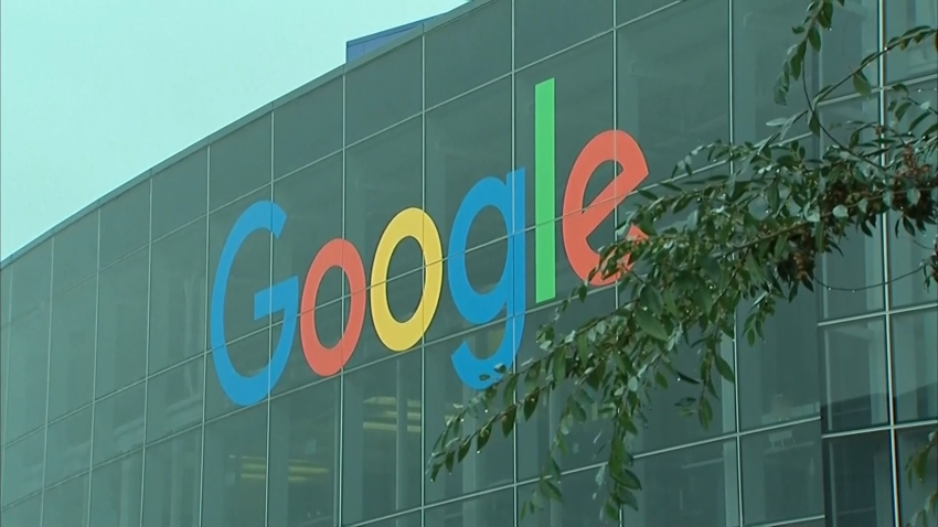 The google logo is placed on the side of a glass building