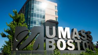 Light catches on the University of Massachusetts Boston sign on June 13, 2020.