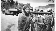 A mujahadeen fighter carries a U.S.-made shoulder-fired Stinger missile during the 1989 Jalalabad offensive in eastern Afghanistan. The weapon is capable of shooting down fast-moving aircraft by locking on to the heat signal generated by the engines.