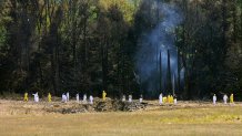 Emergency workers look over the site where the Boeing 757 of United Airlines crashed near Shanksville, Pennsylvania.