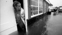 An employee watches Eel Pond flood into Shuckers in Woods Hole, Mass., on Aug. 19, 1991, during Hurricane Bob.