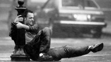 A man holds on to a pole in downtown Boston during Hurricane Bob on Aug. 19, 1991.