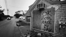 A board put up to protect a deli in Menemsha, Mass., on Martha's Vineyard, carries a challenge to the elements on Aug. 20, 1991, ahead of Hurricane Bob.