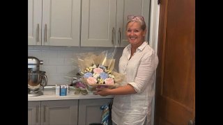 Lisa Mackin, owner and operator of Boston Baked Blooms, in her South Boston kitchen with the edible cupcakes bouquets she makes there.