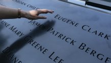 ésirée Bouchat reaches towards the inscribed name of James Patrick Berger at the National September 11 Memorial