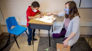 Teacher assists student in DC school