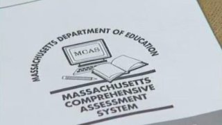 a paper shows the cover of the Massachusetts Comprehensive Assessment System, or MCAS