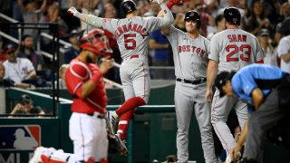 Boston Red Sox's Enrique Hernandez high fiving Bobby Dalbec