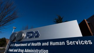 FILE- In this Dec. 10, 2020, file photo, a sign is displayed for the Food and Drug Administration in Silver Spring, Md. After nearly nine months of searching, President Joe Biden says he’s close to naming his choice to lead the FDA, which oversees vaccines, drugs and tests.