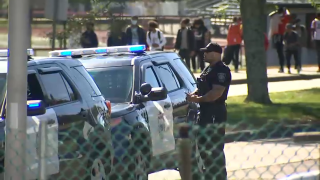 A Brockton police officer outside Brockton High School, where a student brought a gun to school on Friday, Oct. 8, 2021.