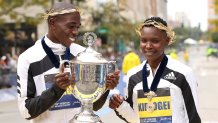 BOSTON, MASSACHUSETTS - OCTOBER 11: Benson Kipruto and Diana Kipyogei of Kenya react after winning the men's and women's divisions of the 125th Boston Marathon on October 11, 2021 in Boston, Massachusetts. (Photo by Maddie Meyer/Getty Images)