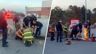 Firefighters rescuing a person trapped in a Concord, New Hampshire, storm drain