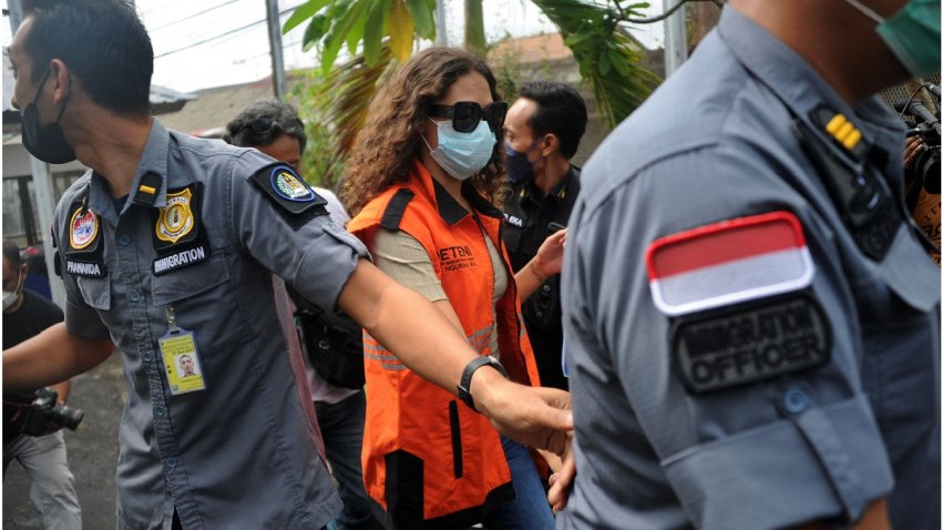 Heather Mack (C) of the US is escorted by Immigration guards to the immigration detention house in Jimbaran, on the resort island of Bali on Oct. 29, 2021.