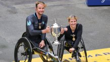 Marcel Hug crossed the Boston Marathon finish line just shy of the world record for the men's wheelchair division and Manuela Schär defended her women's wheelchair title.