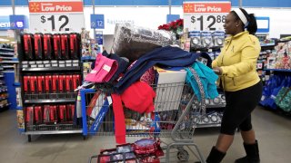 A shopper heads to checkout at a Walmart Store in Chicago, November 23, 2012.