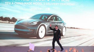 Tesla CEO Elon Musk gestures during the Tesla China-made Model 3 Delivery Ceremony in Shanghai.