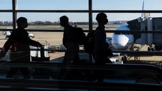 Travelers walk through Terminal A at Ronald Reagan Washington National Airport Nov. 23, 2021.