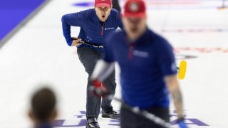 Team Shuster's John Shuster yells to his teammates as they sweep to curl the rock he threw while competing against Team Dropkin during the third night of finals at the U.S. Olympic Curling Team Trials at Baxter Arena in Omaha, Neb., Sunday, Nov. 21, 2021.