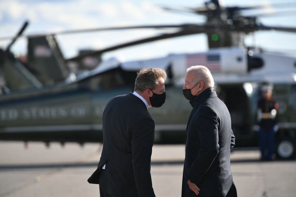 President Joe Biden is greeted by New Hampshire Gov. Chris Sununu as he steps off Air Force One upon arrival at Manchester-Boston Regional Airport in Manchester, New Hampshire, on Tuesday, Nov. 16, 2021. Biden was headed to Woodstock, New Hampshire, to promote his infrastructure bill.