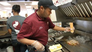 WATERTOWN, MA – OCTOBER 24: D’Angelo’s is having a menu makeover geared toward a younger client list. Jose Bruno makes one of the new sandwiches—Chipotle Steak. (Photo by Suzanne Kreiter/The Boston Globe via Getty Images)