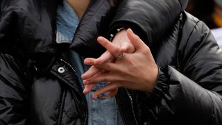 A couple hold hands, during Pope Francis Angelus noon prayer in St. Peter's Square