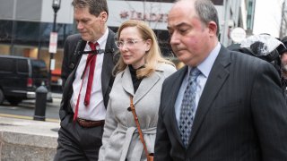 Marci Palatella, founder of Preservation Distillery, center, arrives at federal court in Boston, Massachusetts, U.S., on Friday, March 29, 2019. Wealthy parents appeared in court as the clock ticks down on plea bargains for their alleged role in the biggest college admissions scam the Justice Department has ever prosecuted.