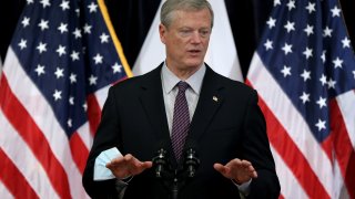 Boston – December 21: Massachusetts Governor Charlie Baker, left, was joined by Health and Human Services Secretary Marylou Sudders, right, at the State House for a COVID-19 update to discuss measures to support the healthcare system in Boston on Dec. 21, 2021.