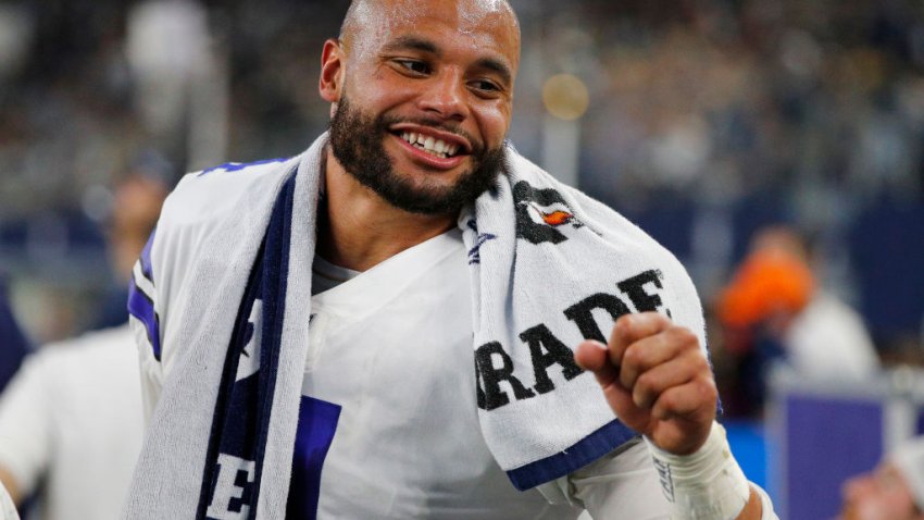 Dak Prescott #4 of the Dallas Cowboys celebrates after a touchdown during the second quarter against the Washington Football Team at AT&T Stadium on December 26, 2021 in Arlington, Texas.