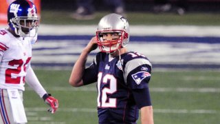 Feb 3, 2008; Glendale, AZ, USA; New England Patriots quarterback Tom Brady (12) walks off the field in the third quarter against the New England Patriots during Super Bowl XLII at the University of Phoenix Stadium. Mandatory Credit: Mark J. Rebilas-USA TODAY Sports