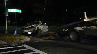 A wrecked SUV at the site of a car crash in Winchester, Massachusetts, late Sunday, Dec. 26, 2021.