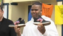 Boston student Jean Dario with the shoes he designed.