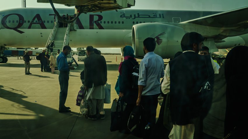 KABUL, AFGHANISTAN — OCTOBER 3, 2021: People prepare to board an evacuation flight out of Kabul, Afghanistan, Sunday, Oct. 3, 2021. (MARCUS YAM / LOS ANGELES TIMES)